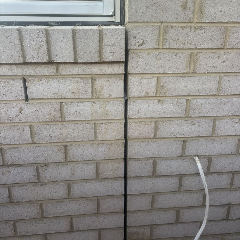 Brick expansion joint left open, needing mastic to keep water out, found during a construction stage inspection in Maddingley