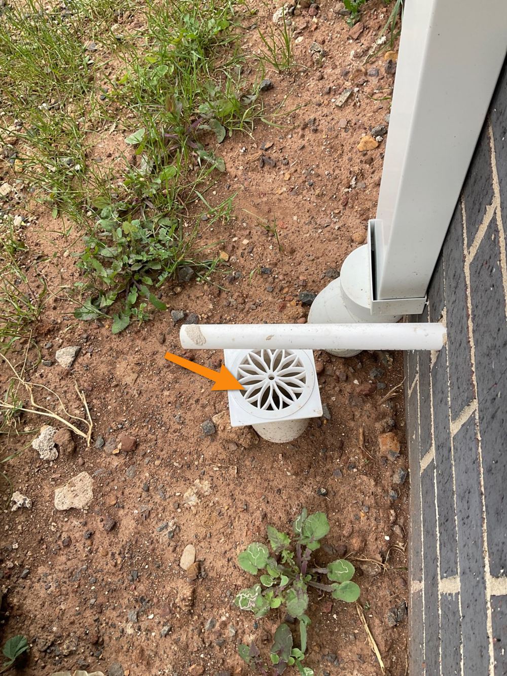Air conditioner drain running onto the ground instead of to stormwater, found during a pre-handover (PCI) inspection in Bacchus Marsh